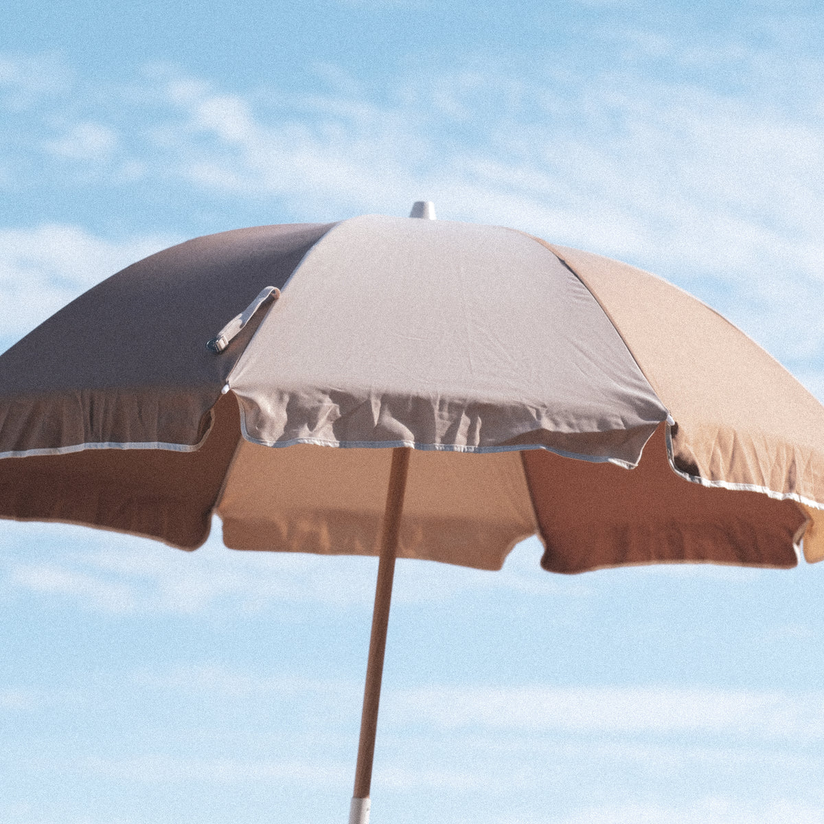 Husk Splice Beach Umbrella canopy and contrast trim against the sky